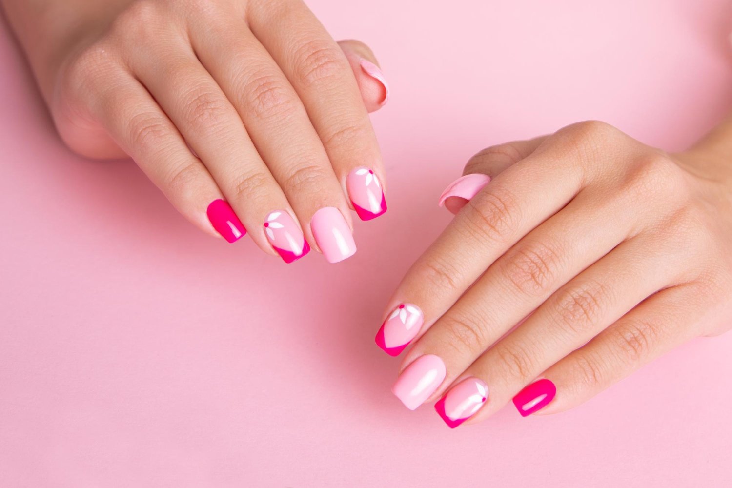 beautiful-female-hands-with-fashion-manicure-nails-flowers-design-pink-gel-polish (1)